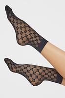 Damskie skarpetki wzorzyste wykonane z przędzy oplatanej typu elastan. Bezuciskowy ściągacz.